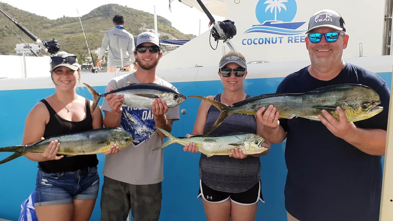 Coconut Reef guests holding the days catch