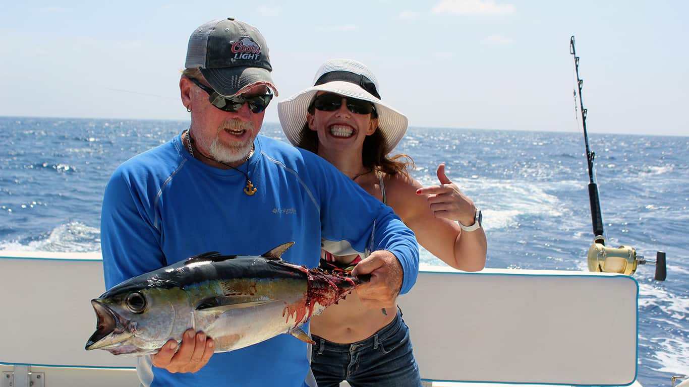 Fishing Crew hold up a Black Fin Tuna